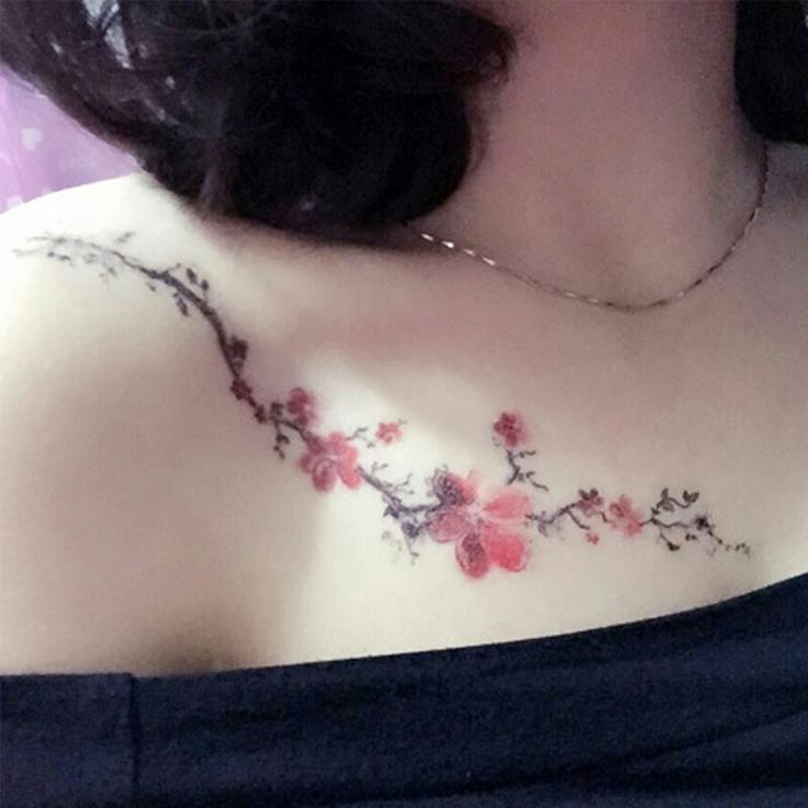 a woman's chest with pink flowers on it