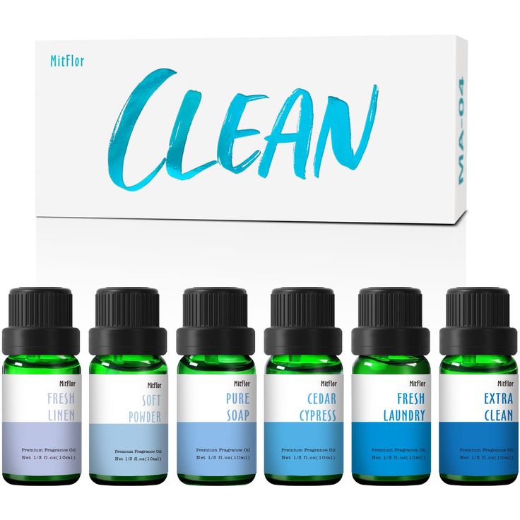 six bottles of clean essential oils in front of a white box with the word clean on it