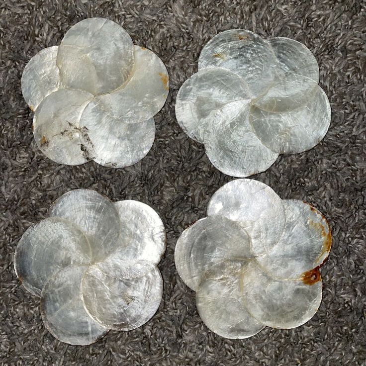 four pieces of metal sitting on top of a carpeted floor next to each other