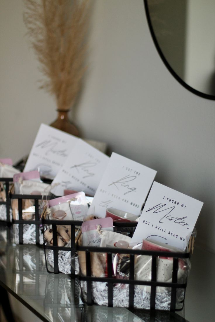 small baskets filled with different types of items on top of a table next to a mirror