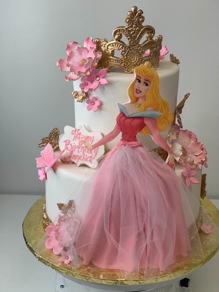 a birthday cake with a princess on top