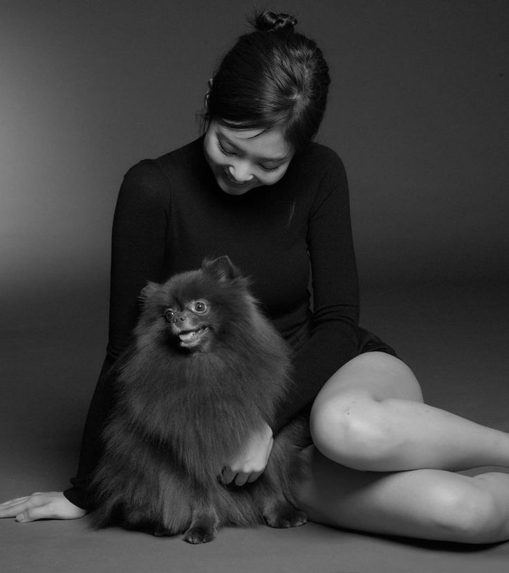 a woman sitting on the floor with her dog