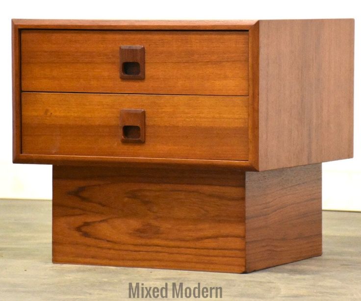 a close up of a wooden dresser with two drawers on each side and one drawer open