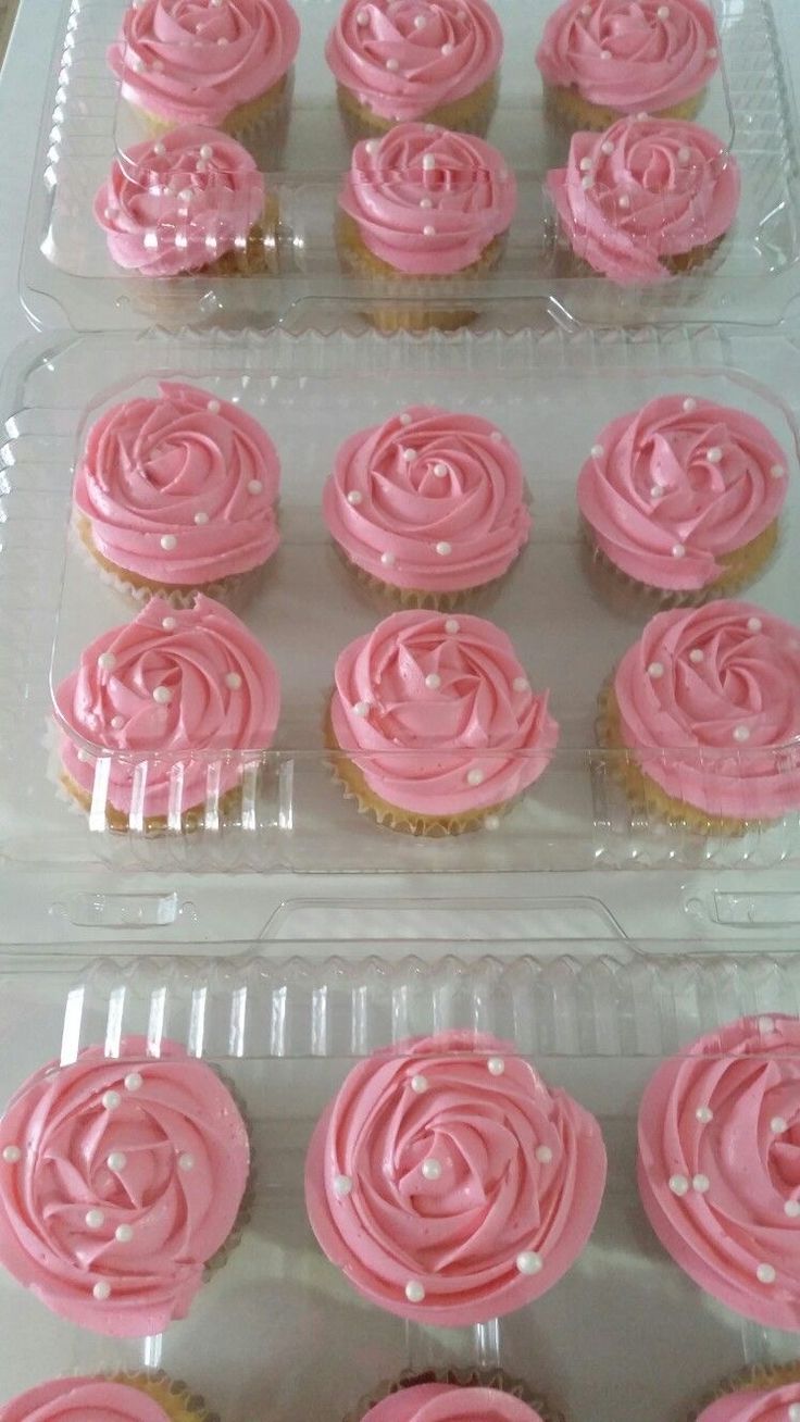 cupcakes with pink frosting in plastic trays