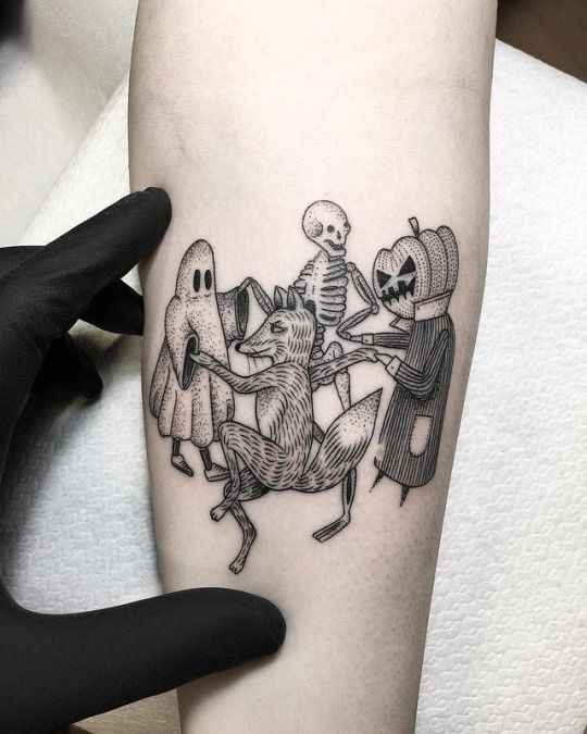 a person with a tattoo on their arm holding onto a skeleton and three other skeletons