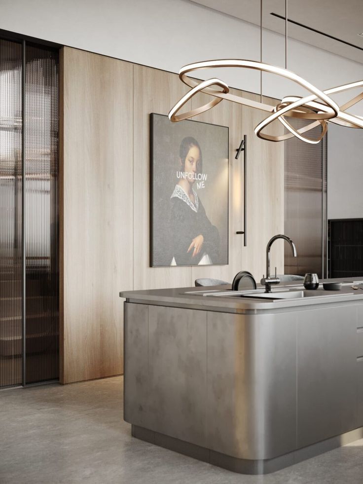 a modern kitchen with an island sink and stainless steel appliances in front of a painting