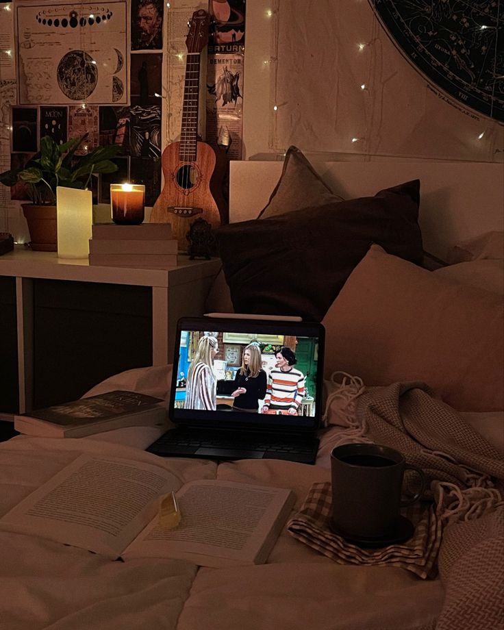 an open laptop computer sitting on top of a bed