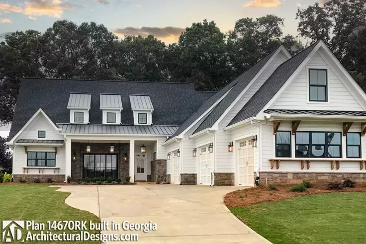 a large white house with lots of windows on it's front porch and driveway