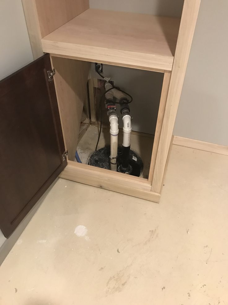 an open cabinet in the corner of a room