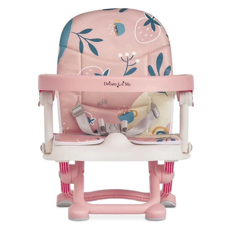 a pink high chair with blue and white flowers on it's seat, in front of a white background