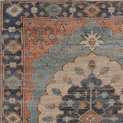 an antique rug with blue and orange colors