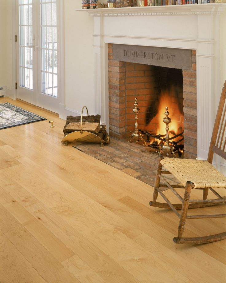 a fireplace with a rocking chair next to it