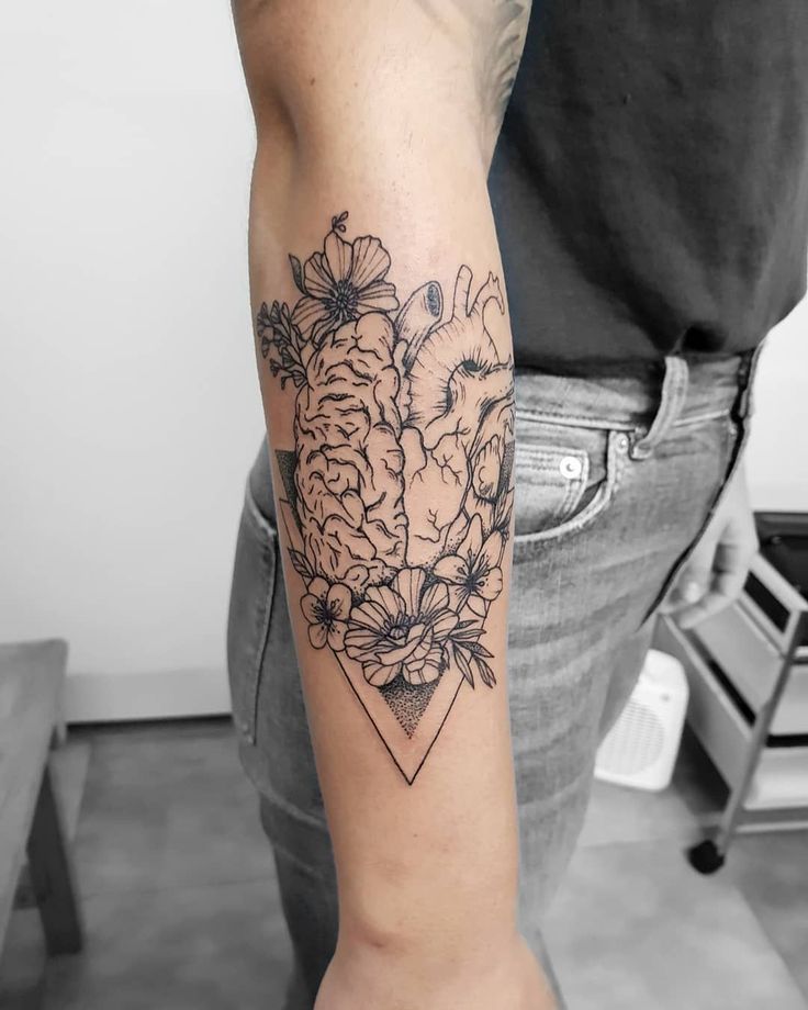 a man's arm with flowers on it and a diamond tattoo design in the middle