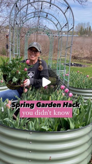 a woman sitting in a garden with lots of flowers inside of it and the words spring garden hack you didn't know