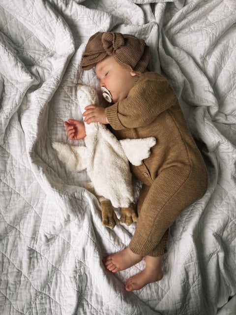 Meet the perfect blend of style and practicality with our luxe knitted romper, crafted to keep your little one comfy and cute! Made from 100% soft cotton, this romper makes it a delightful choice for all-day wear. Features: The Luxe Romper is accented with charming wooden buttons along the body, this romper adds a touch of rustic charm to your baby’s wardrobe. The button snaps at the bottom ensure that diaper changes are a breeze, allowing you to focus on all the fun moments in between! Available in a selection of neutral colors, it’s easy to mix and match with your baby’s favorite accessories. Mix and match with our matching luxe accessories including our beanie, booties or topknot. SIZING *We recommend sizing up, as this romper tends to run small. If your child is between sizes, we highl Knit Bow, Fun Moments, Family Outings, Knit Headband, Toddler Bows, Knitted Romper, Family Outing, Wooden Buttons, Stylish Kids