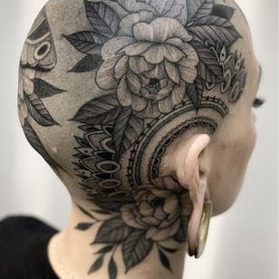 a woman's head with tattoos on it