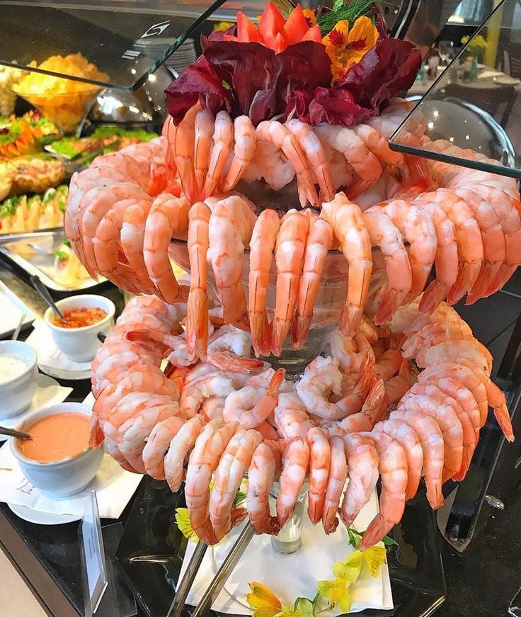 shrimp and other foods are arranged on a buffet table