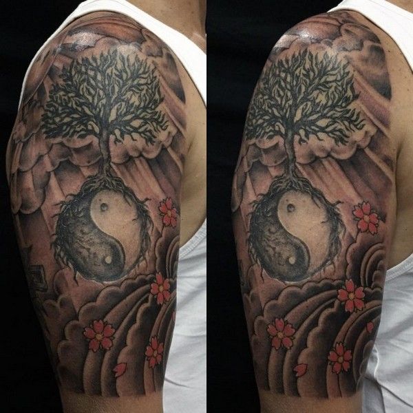 a man's half sleeve with a tree and rocks on it