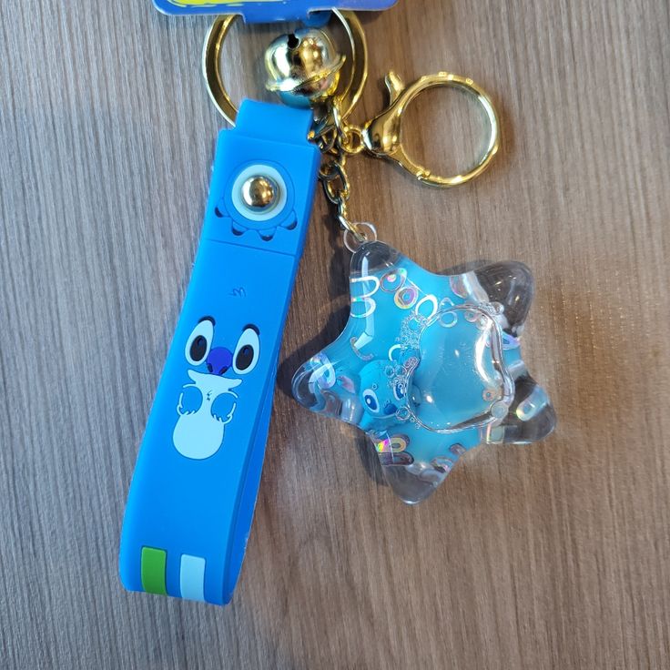 a keychain with a cartoon character on it and a plastic object in the shape of a toothbrush