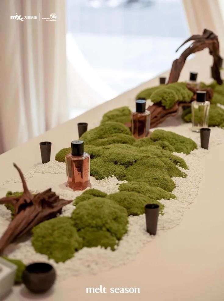 moss covered table with bottles and candles on it