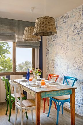 a dining room table with chairs and plates on it