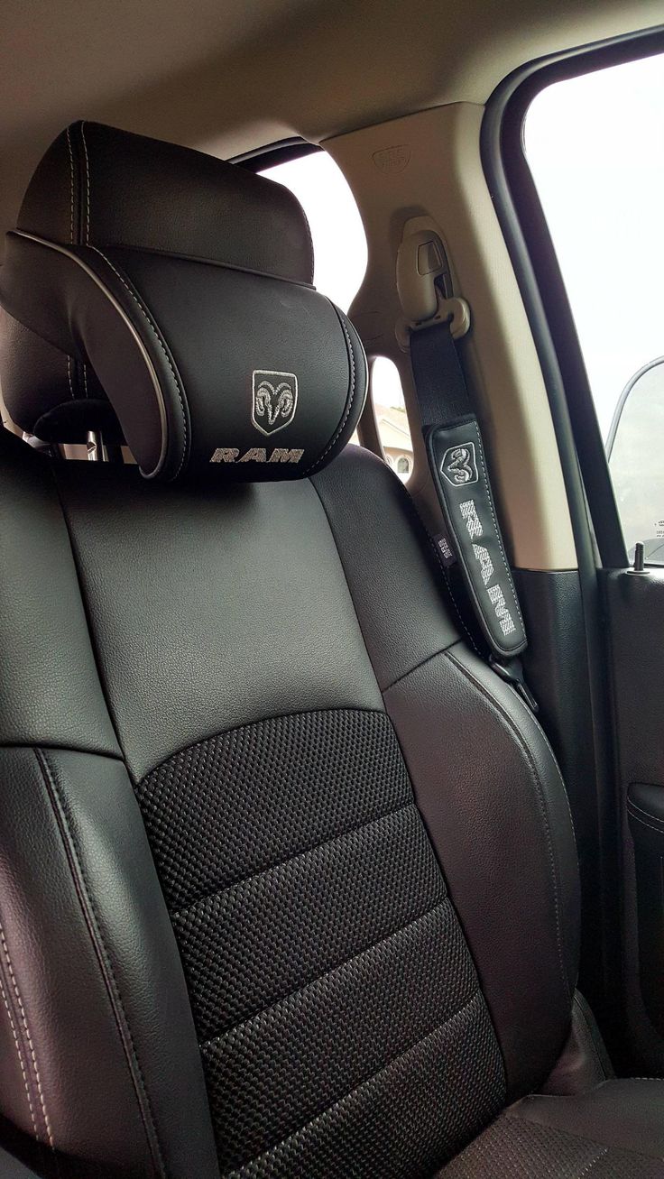 the interior of a car with black leather seats and matching headrests, in front of an open window