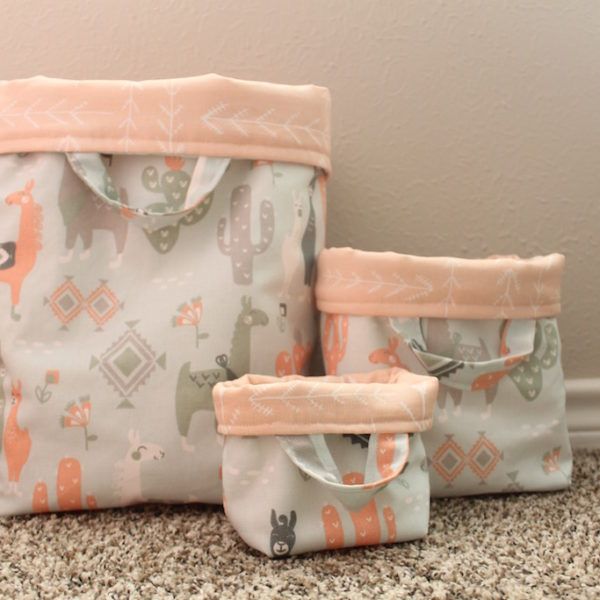 three bags sitting on top of a carpet covered floor next to a wall with an animal print