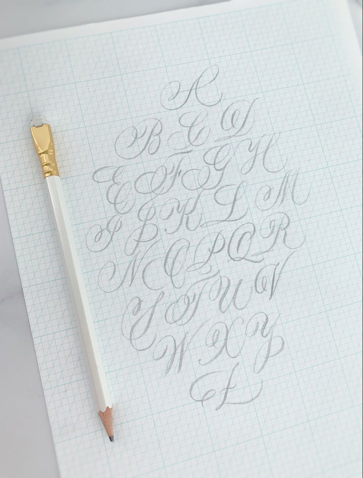 a pen is sitting on top of a sheet of paper with cursive writing