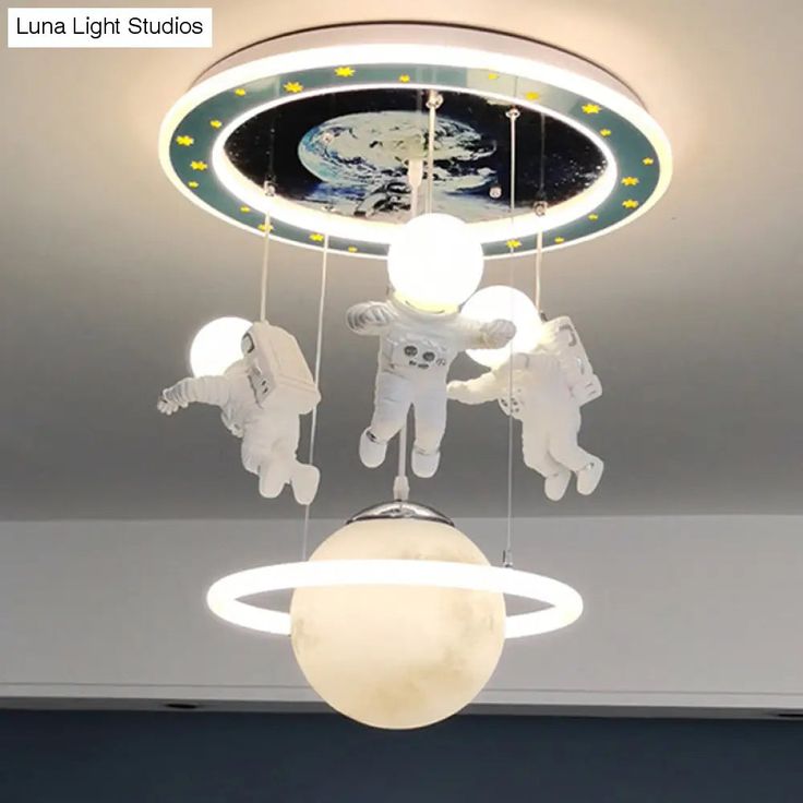 an astronaut mobile is suspended from the ceiling