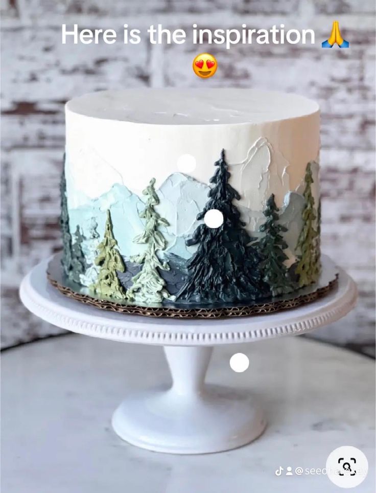 there is a white cake with trees on it and the words here is the inspiration