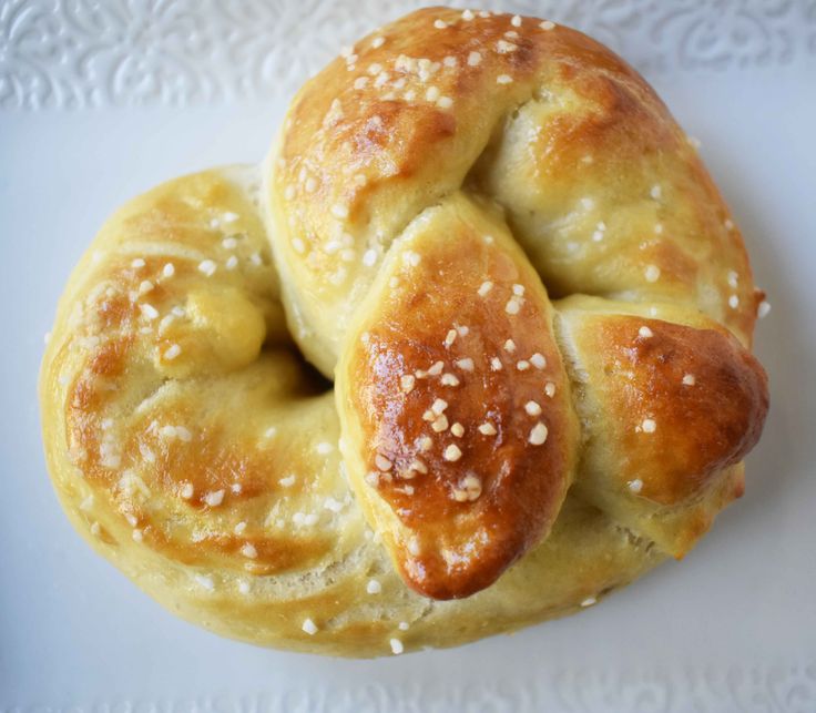 a close up of a doughnut on a plate with sesame seed sprinkles