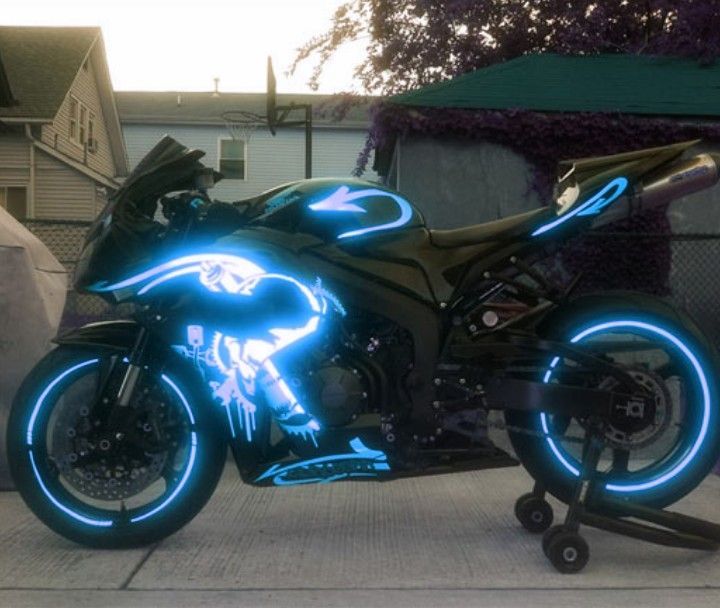 a black motorcycle with blue neon lights on it