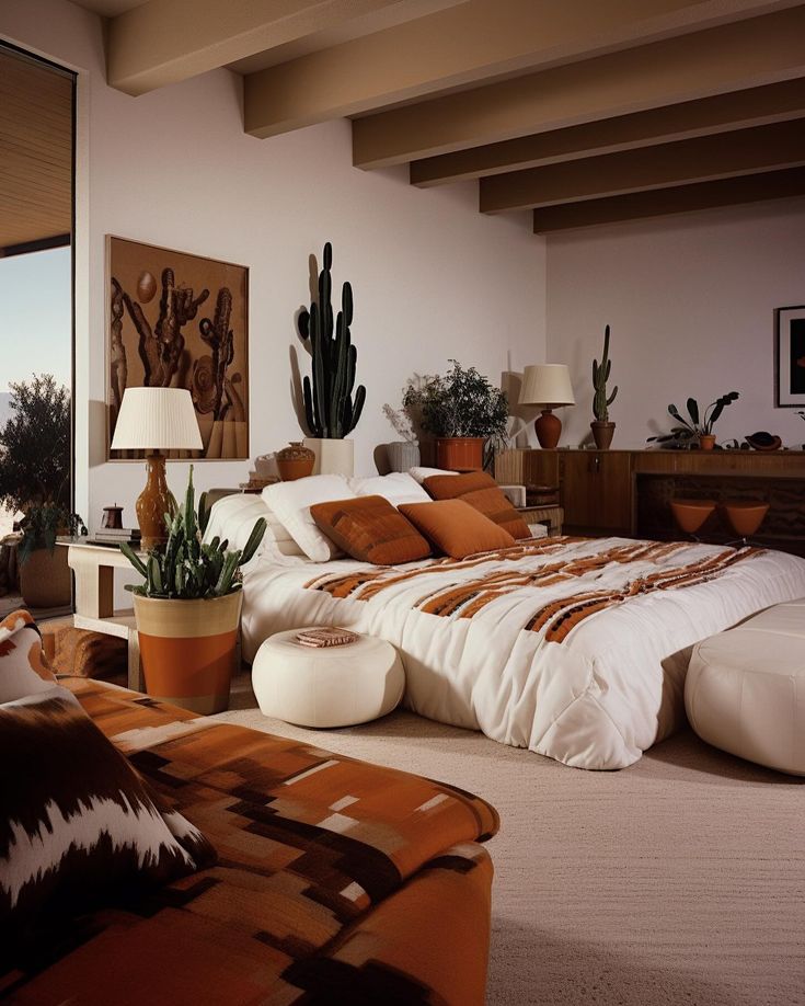 a large bed sitting in a bedroom next to a window with potted plants on top of it