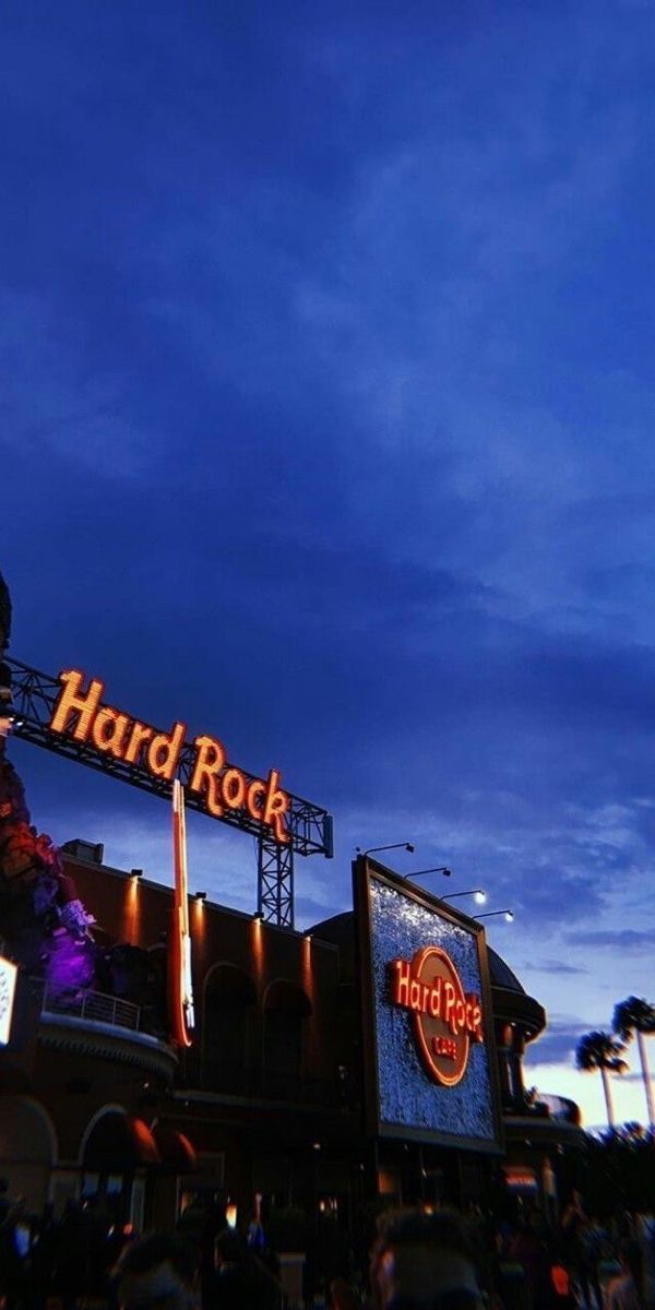 the hard rock sign is lit up at night