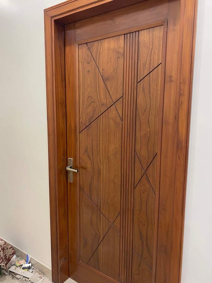 a large wooden door sitting in the corner of a room