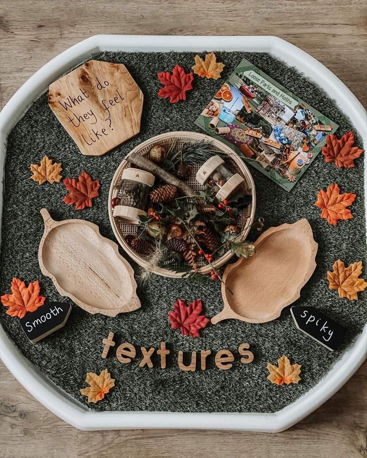 a bowl filled with wooden spoons sitting on top of a table next to other items