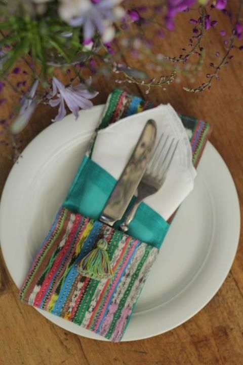 a plate with a fork and knife on it next to purple flowers in the background