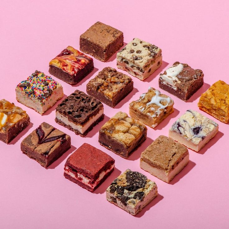 an assortment of different types of desserts on a pink background with one half eaten