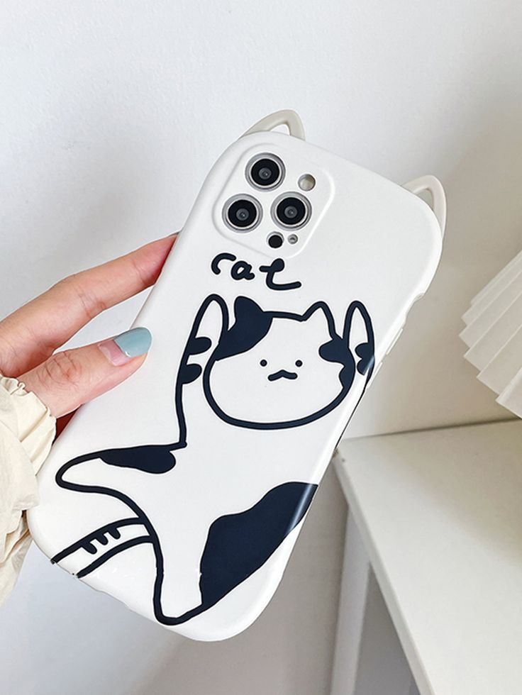 a person holding up a phone case with a cat design on the front and back