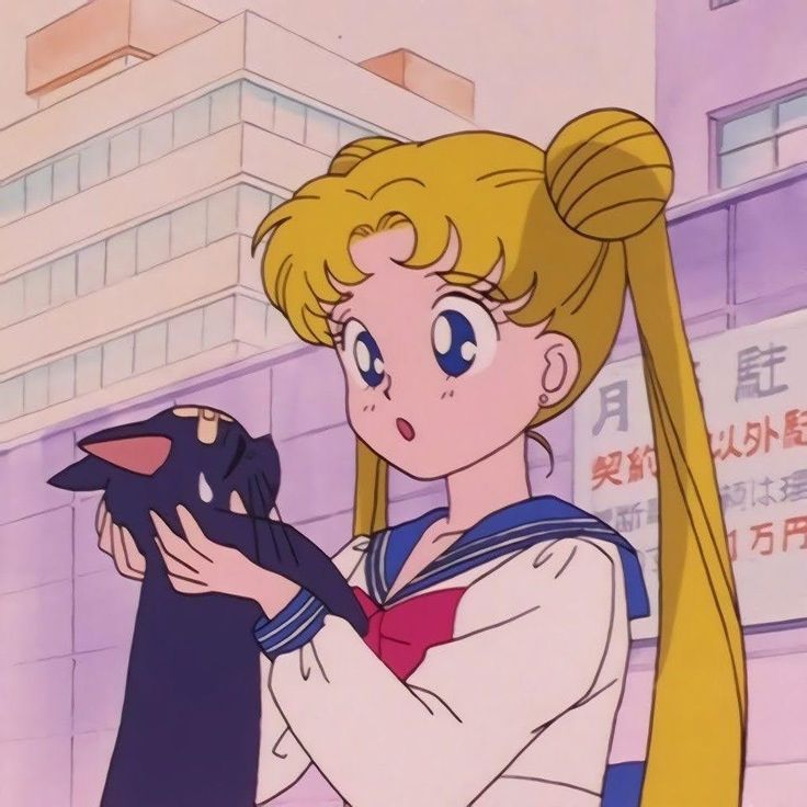 sailor girl holding a black cat in her hands