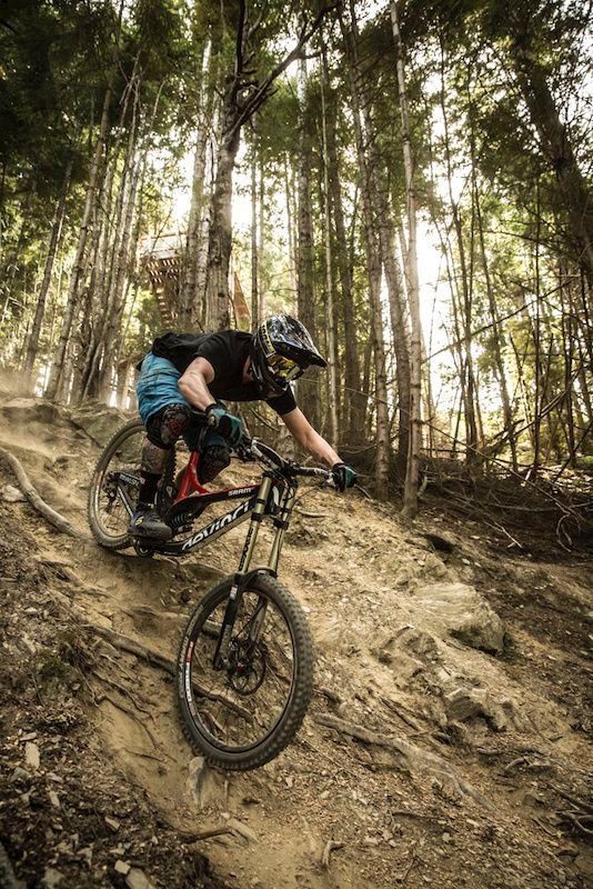 a man riding a mountain bike down a dirt trail