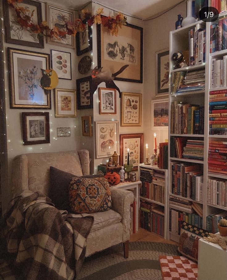 a living room filled with lots of books and pictures hanging on the wall next to a couch