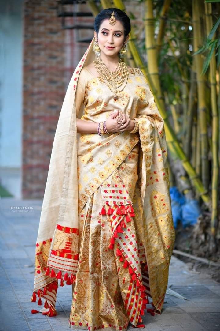 a woman in a yellow and red sari