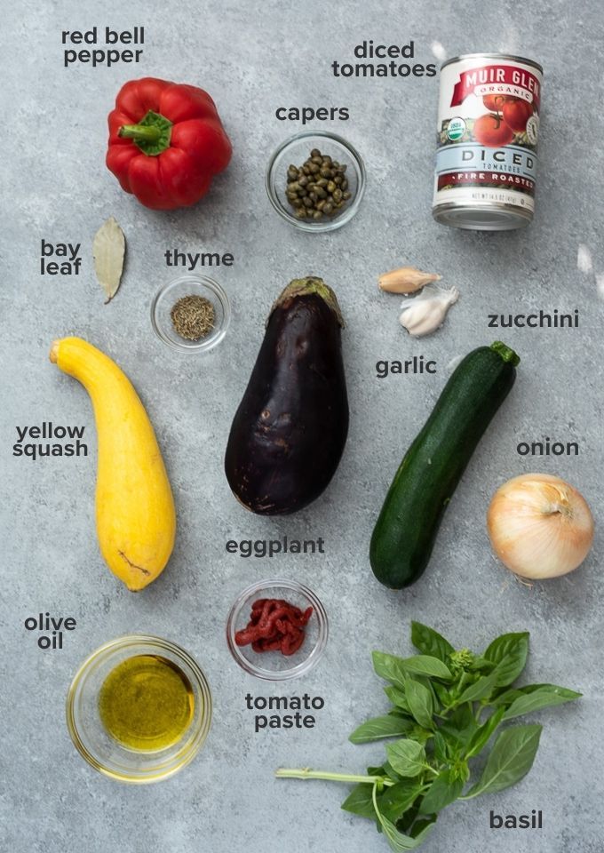 the ingredients to make an eggplant soup laid out on top of a table