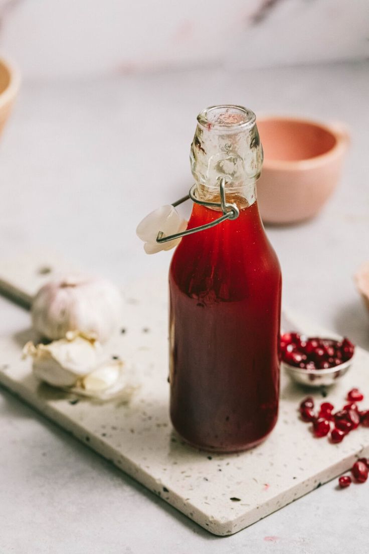 a bottle filled with liquid sitting on top of a cutting board