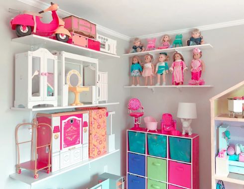 a room filled with lots of toy furniture and toys on top of bookshelves