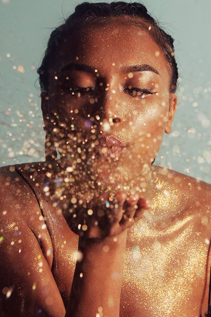 a woman with her hands on her face and water droplets all over her body as she looks at the camera