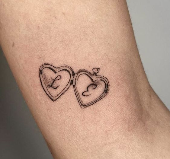 two heart shaped tattoos on the arm