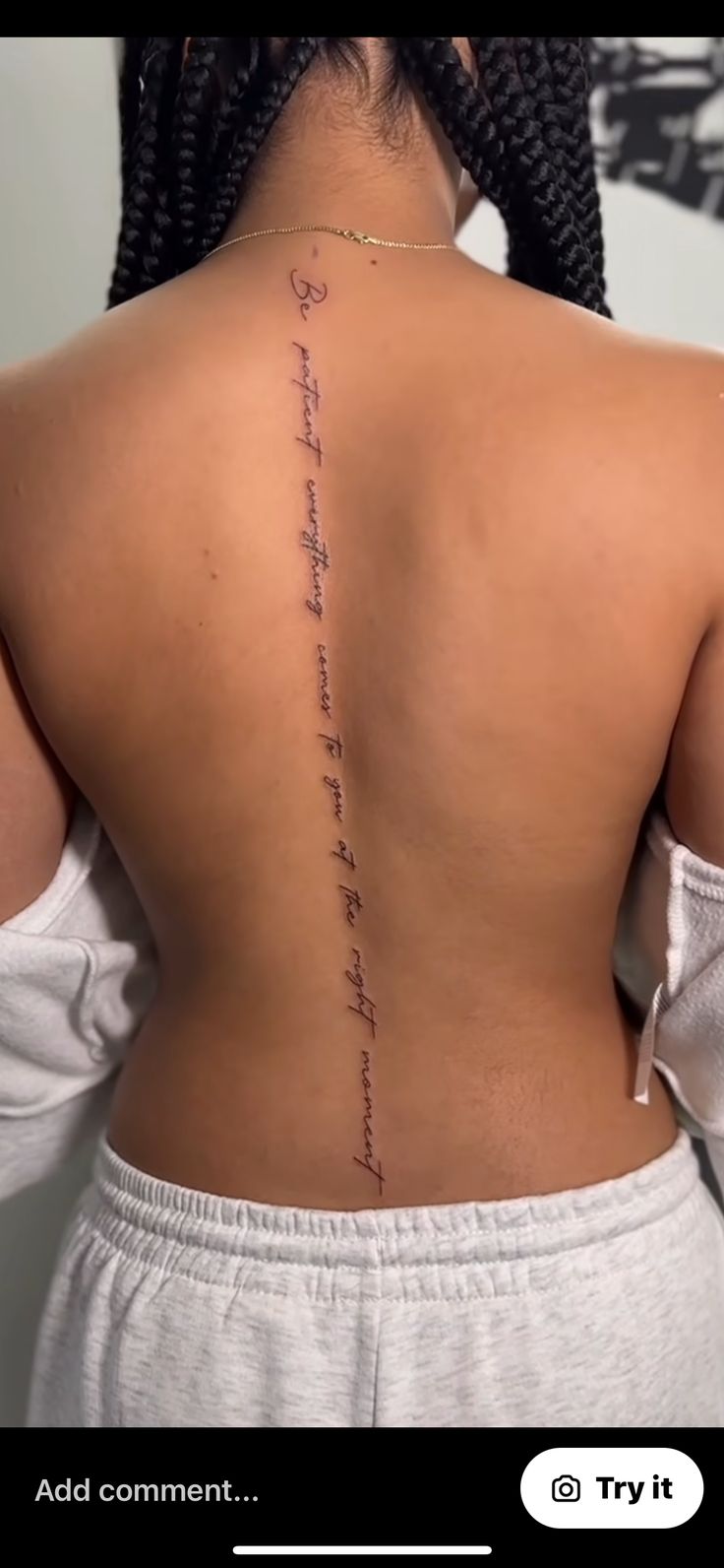 the back of a woman's neck with an inscription on her left side and words written in cursive writing