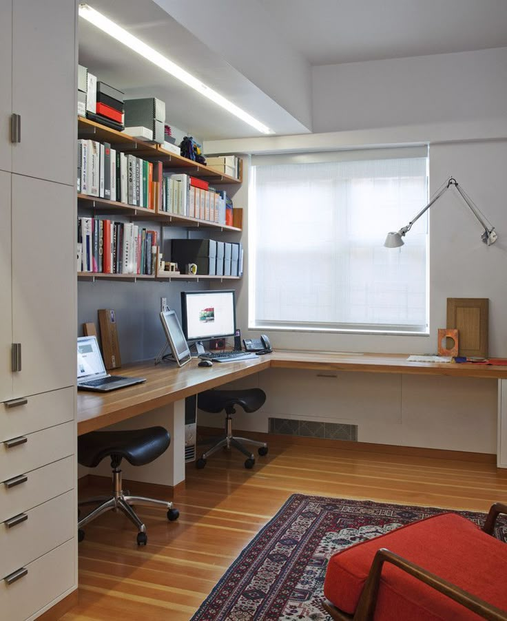 a home office with desk, computer and bookshelf